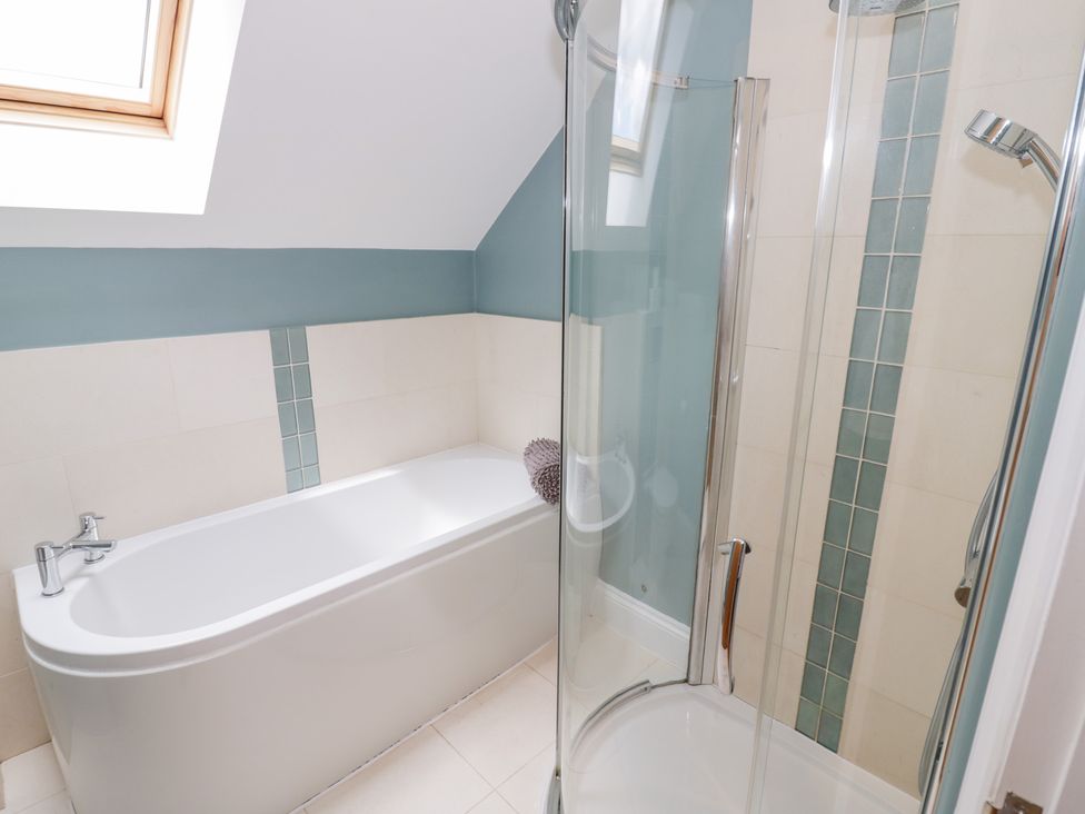 A bathroom with a bathtub and shower at Filly Brook in Bishop's Frome
