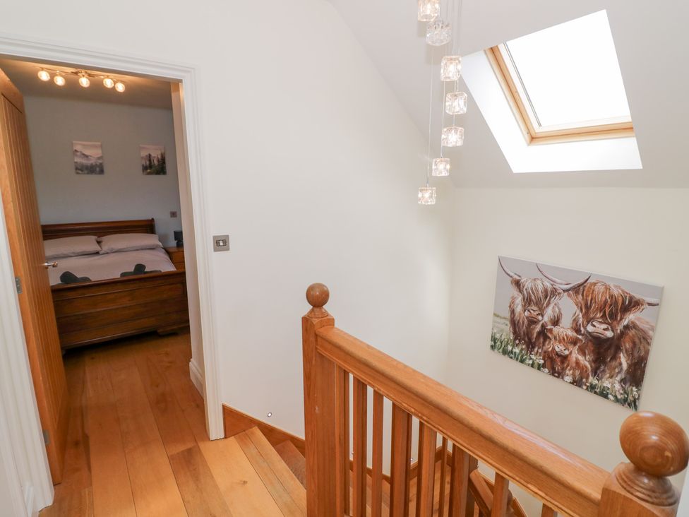 A staircase with a bedroom door and painting at Filly Brook in Bishop's Frome