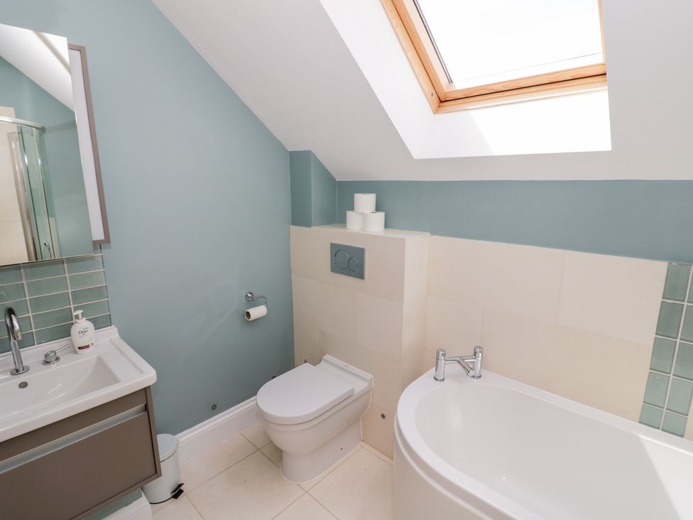 A bathroom with a bathtub and sink at Filly Brook in Bishop's Frome