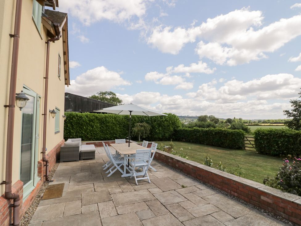 An outdoor dining area with table and chairs at Filly Brook in Bishop's Frome