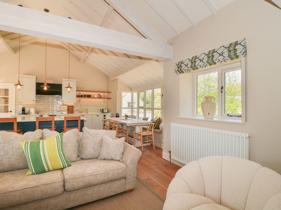 A living room and kitchen area with seating and a dining table at Cleveley Mill in Enstone
