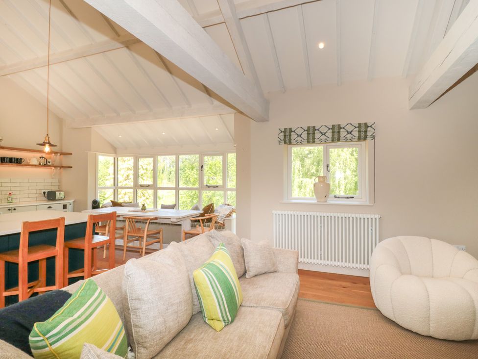 A living room with a sofa and dining area at Cleveley Mill in Enstone