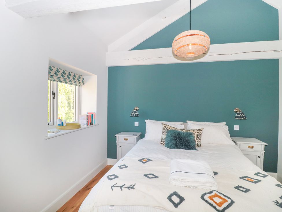 A bedroom with a bed and bedside tables at Cleveley Mill in Enstone