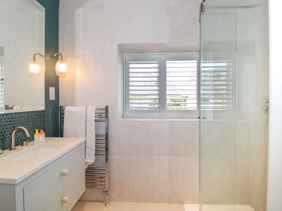 A bathroom featuring a sink, towel rack, and shower at Cleveley Mill in Enstone