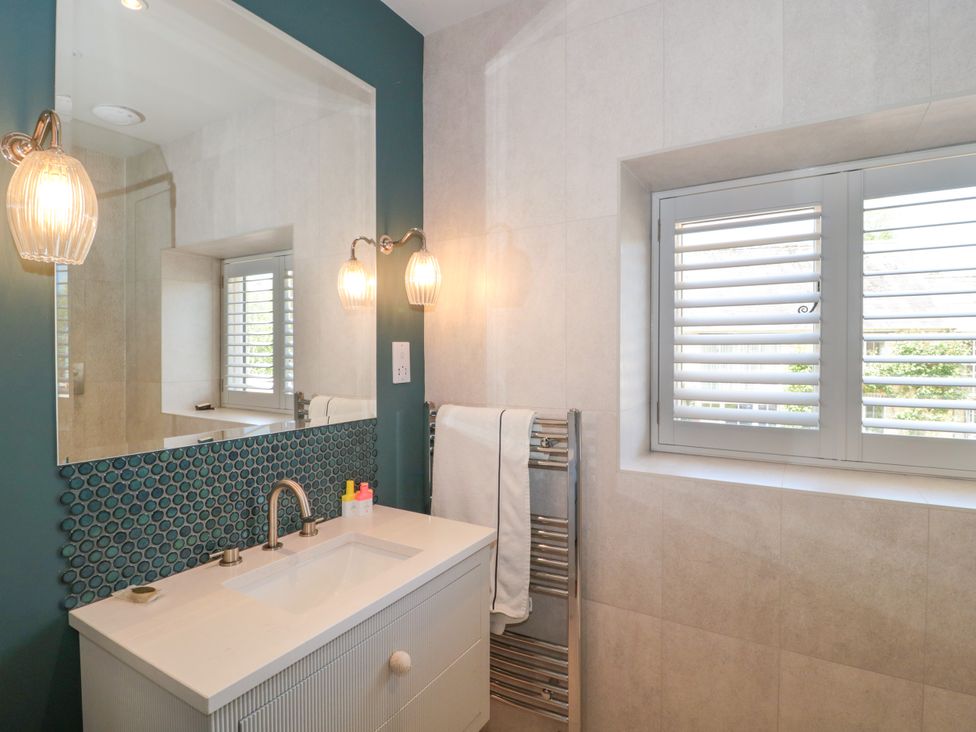 A bathroom with sink and towel rack at Cleveley Mill in Enstone
