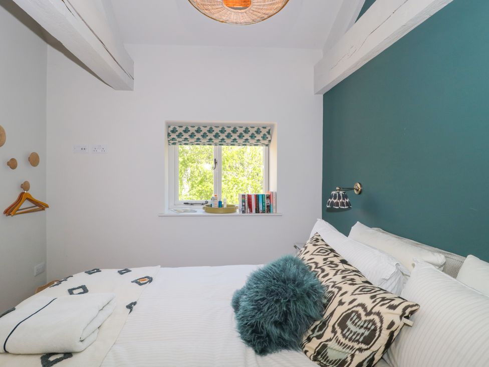 A bedroom with a bed and a window at Cleveley Mill in Enstone