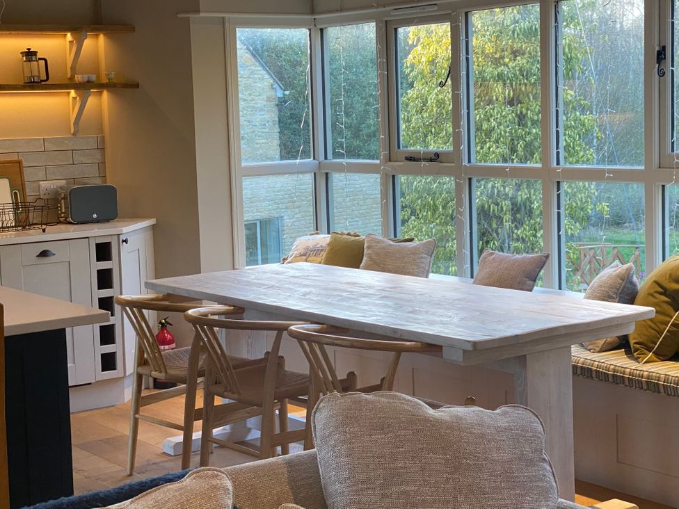 A dining room with a table and chairs at The Annexe, Cleveley Mill Chipping Norton
