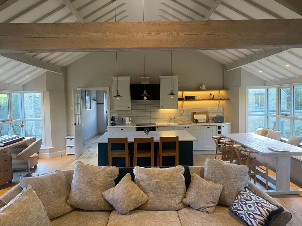 A living room with a kitchen and dining area at The Annexe, Cleveley Mill, Chipping Norton
