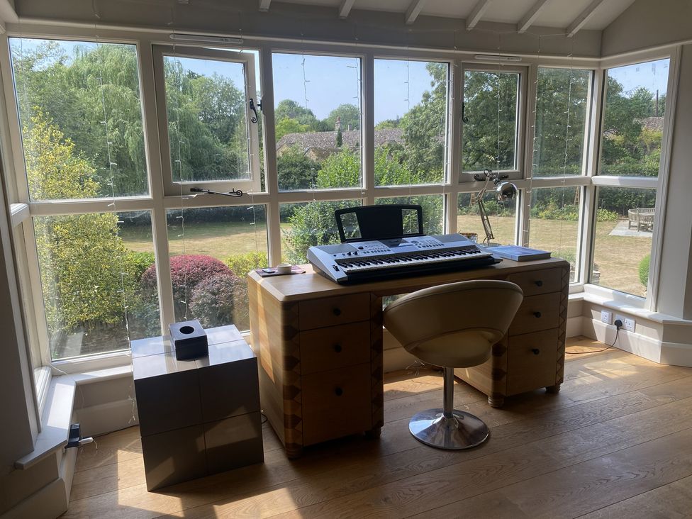 A study with a desk and keyboard at The Annexe, Cleveley Mill, Enstone