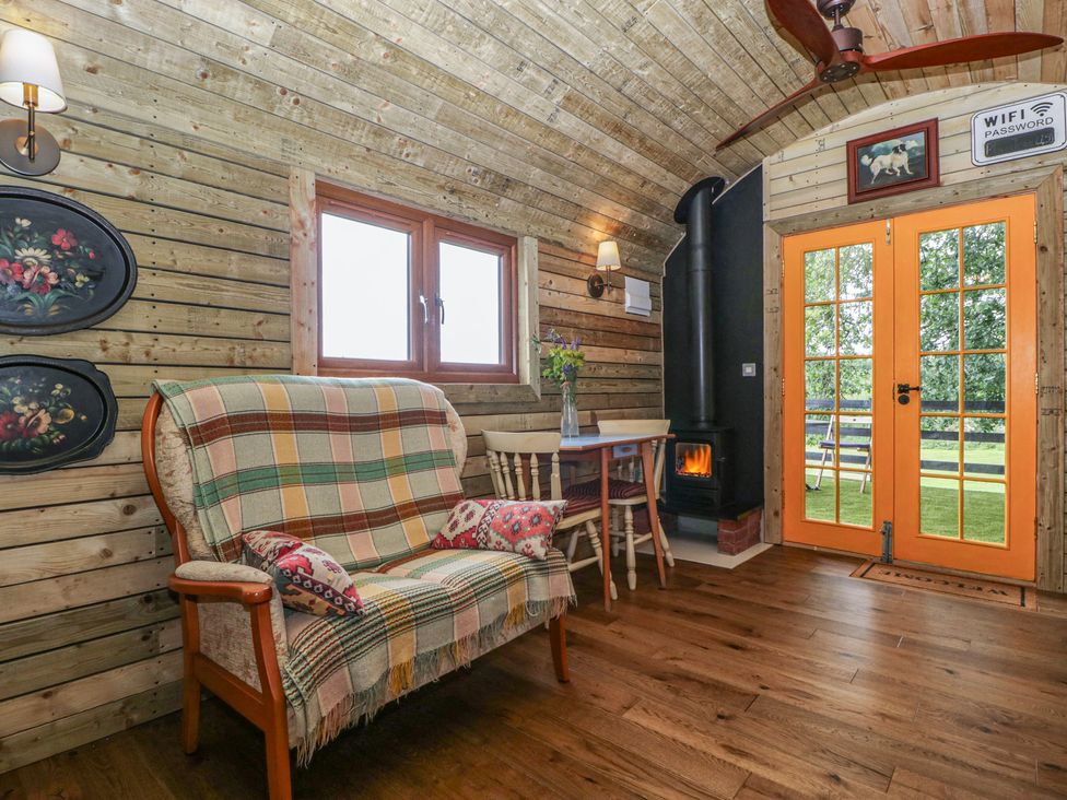 A seating area with a table and chairs at Shepherd Hut’s Bristol