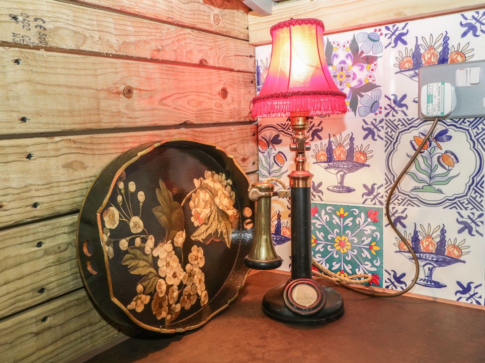 A lamp and decorative tray in a rustic space at Shepherd Hut’s Bristol