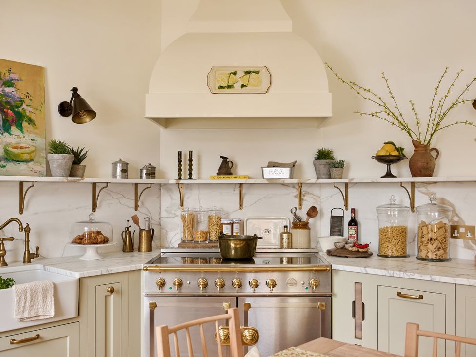 A kitchen with a stove, sink, and various kitchenware at Castle Corner, The Georgian House in Ludlow