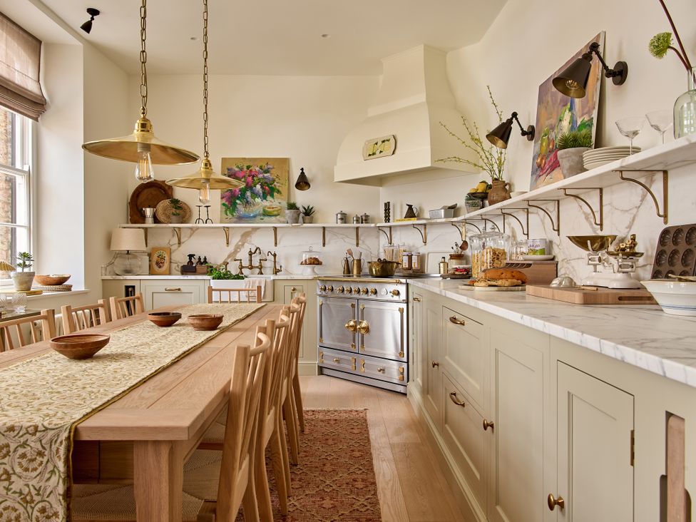 A kitchen with a wooden table and cooking range at Castle Corner, The Georgian House, Ludlow