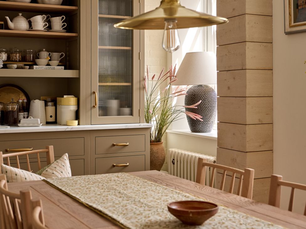 A dining room with a wooden table and chairs at Castle Corner, The Georgian House in Ludlow