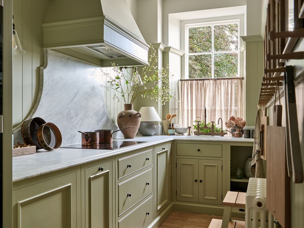 A kitchen with cabinets and a marble countertop at Castle Corner, The Georgian House, Ludlow