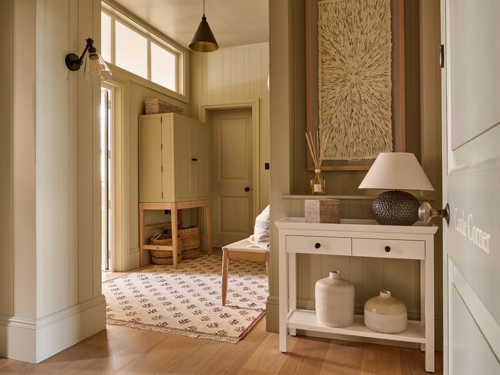 A hallway with a table and lamp at Castle Corner, The Georgian House in Ludlow