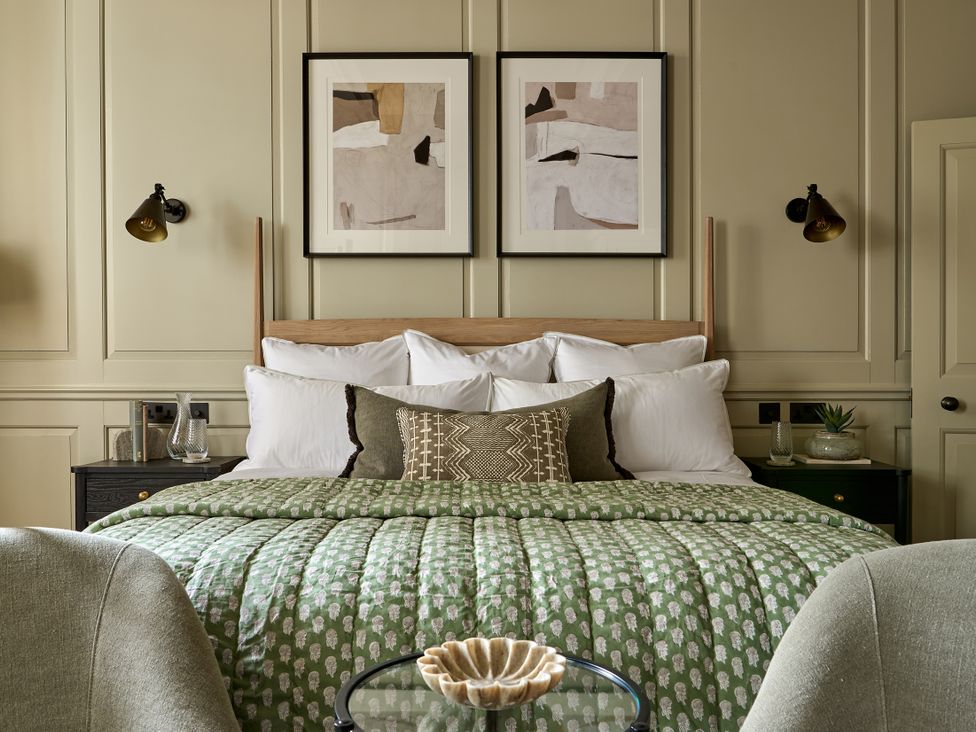 A bedroom with a bed and artworks on the wall at Castle Corner, The Georgian House, Ludlow