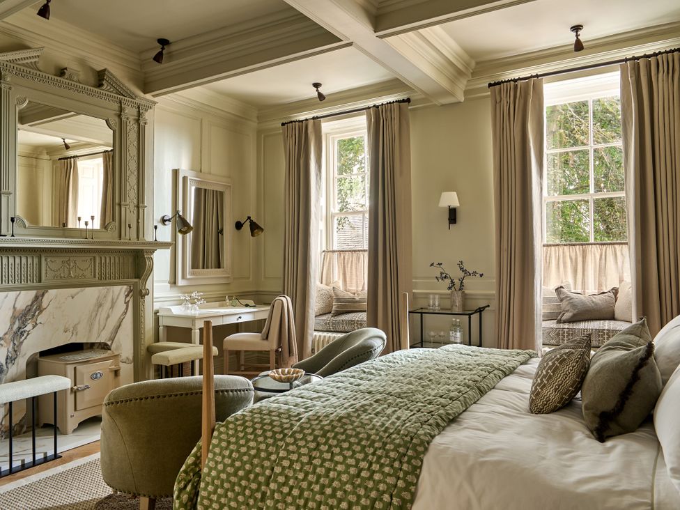 A bedroom with a bed, mirror and windows at Castle Corner, The Georgian House, Ludlow