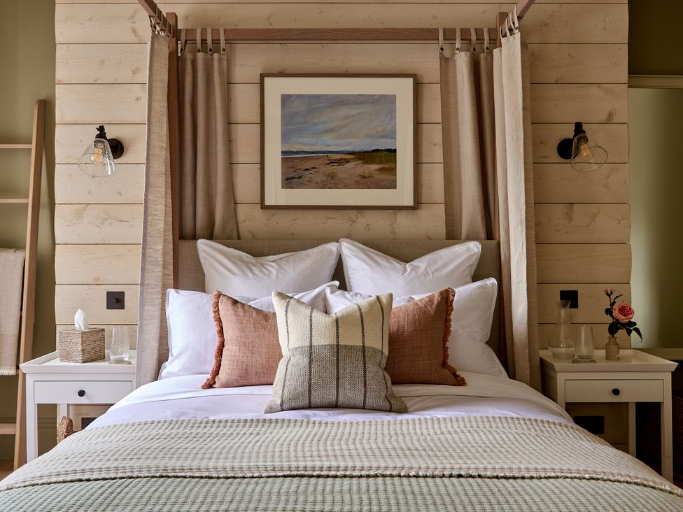 A bedroom with a bed, pillows, and a bedside table at Castle Corner, The Georgian House in Ludlow
