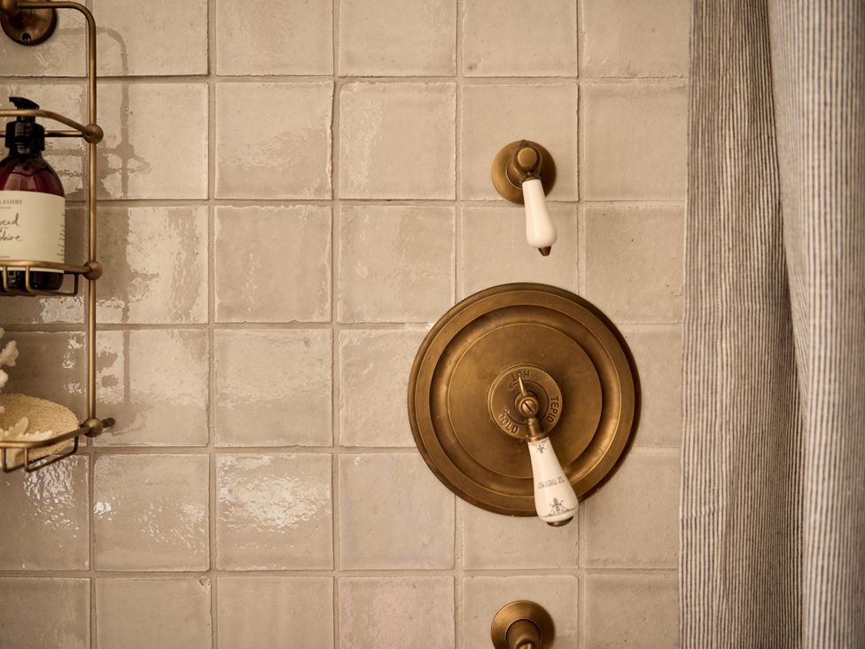 A shower control and soap dispenser in a bathroom at Castle Corner, The Georgian House in Ludlow