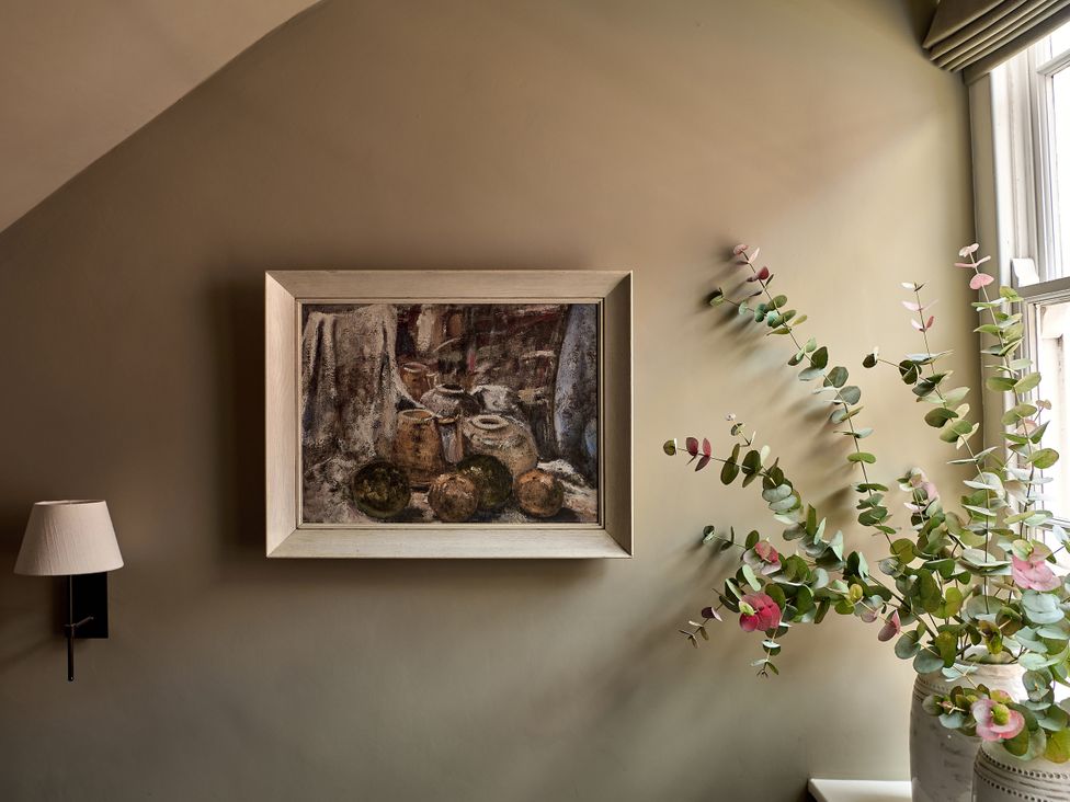 A painting and a eucalyptus plant in a living room at Castle Corner, The Georgian House in Ludlow