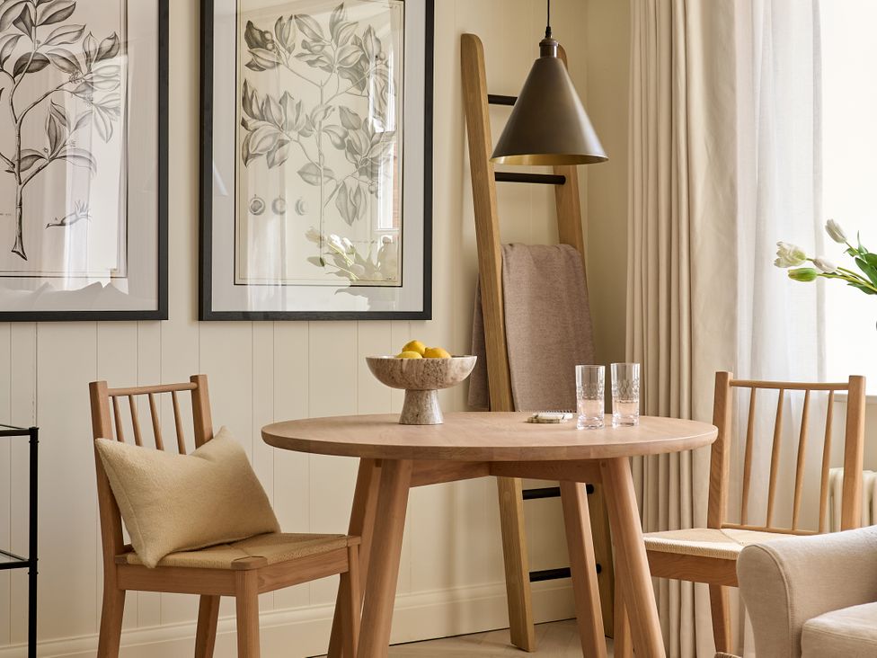A dining room with a round table and chairs at Market View - The Georgian House Ludlow