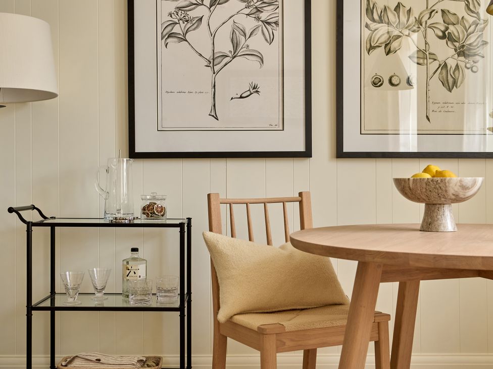 A dining room with a table, chair, and artwork at Market View - The Georgian House in Ludlow