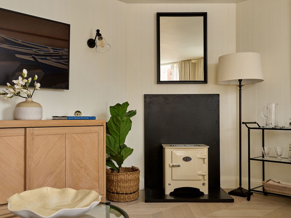 A living room with a television and a storage cabinet at Market View - The Georgian House in Ludlow
