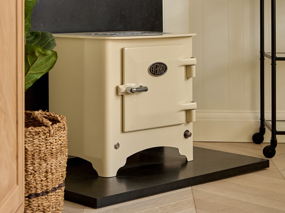 A kitchen with a stove and a basket at Market View - The Georgian House in Ludlow