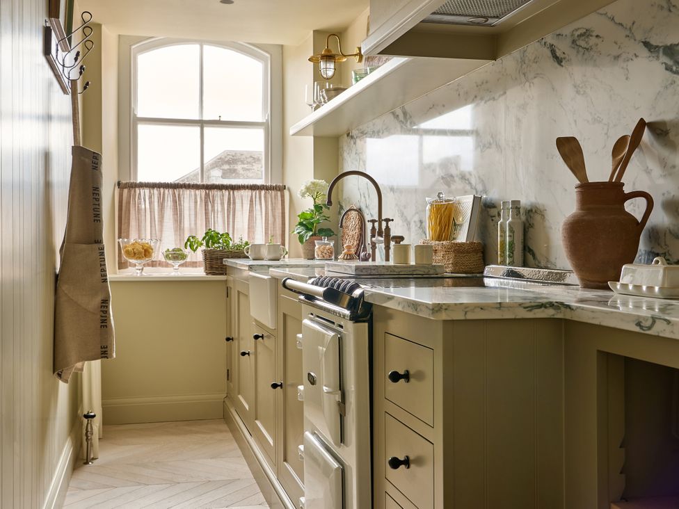 A kitchen with a window, sink, and stove at Market View - The Georgian House in Ludlow