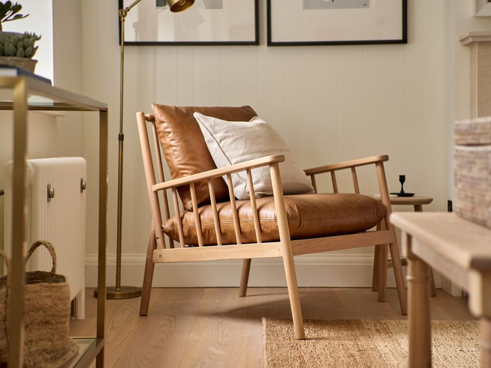 A chair with a cushion in a living room at Stretton Hills Peaks - The Georgian House, Ludlow