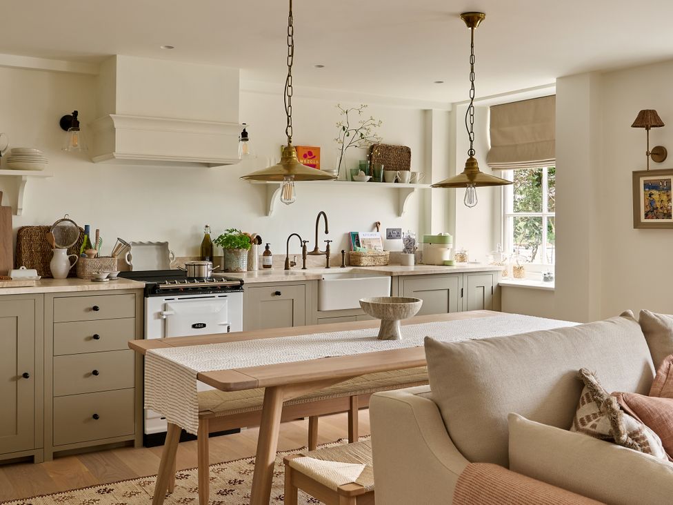A kitchen with a table and sofa at Stretton Hills Peaks - The Georgian House in Ludlow