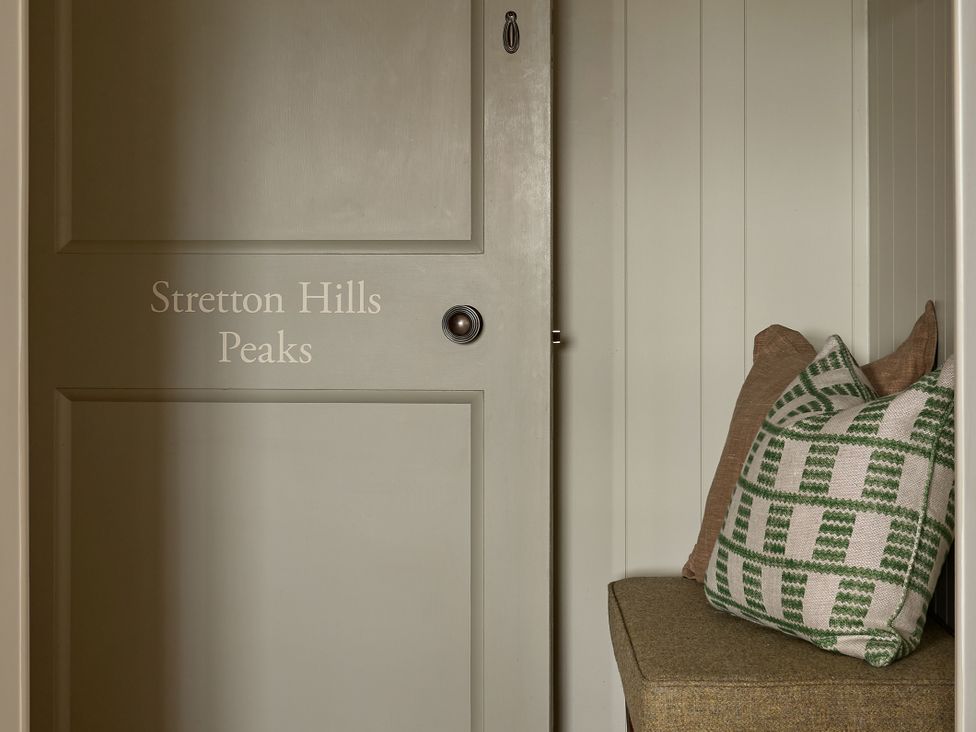 An entryway with a door and a bench at Stretton Hills Peaks in Ludlow
