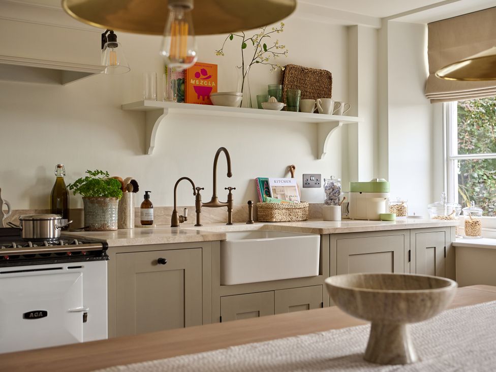 A kitchen with a sink, stove, and shelves at Stretton Hills Peaks - The Georgian House in Ludlow