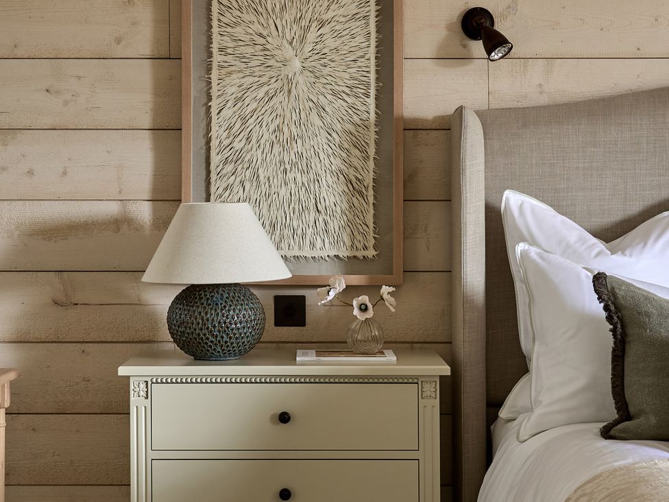A bedroom with a nightstand and lamp at Stretton Hills Peaks - The Georgian House in Ludlow