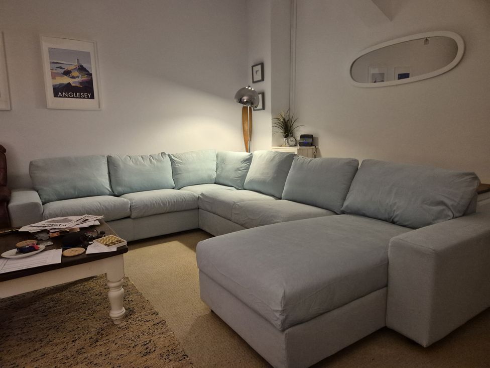 A living room with a sofa and side table at Lady of the Lake Suite