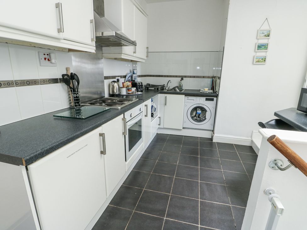 A kitchen with appliances and countertop at Lady of the Lake Suite Trearddur Bay