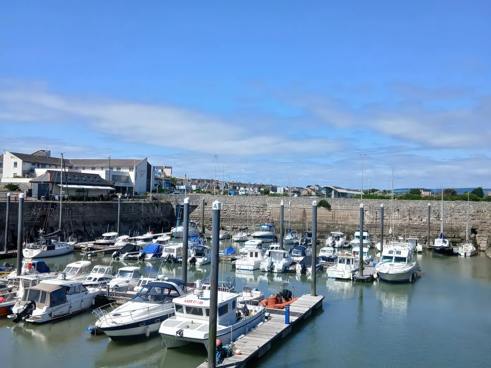 A marina with boats and buildings at Pines 15 in Porthcawl