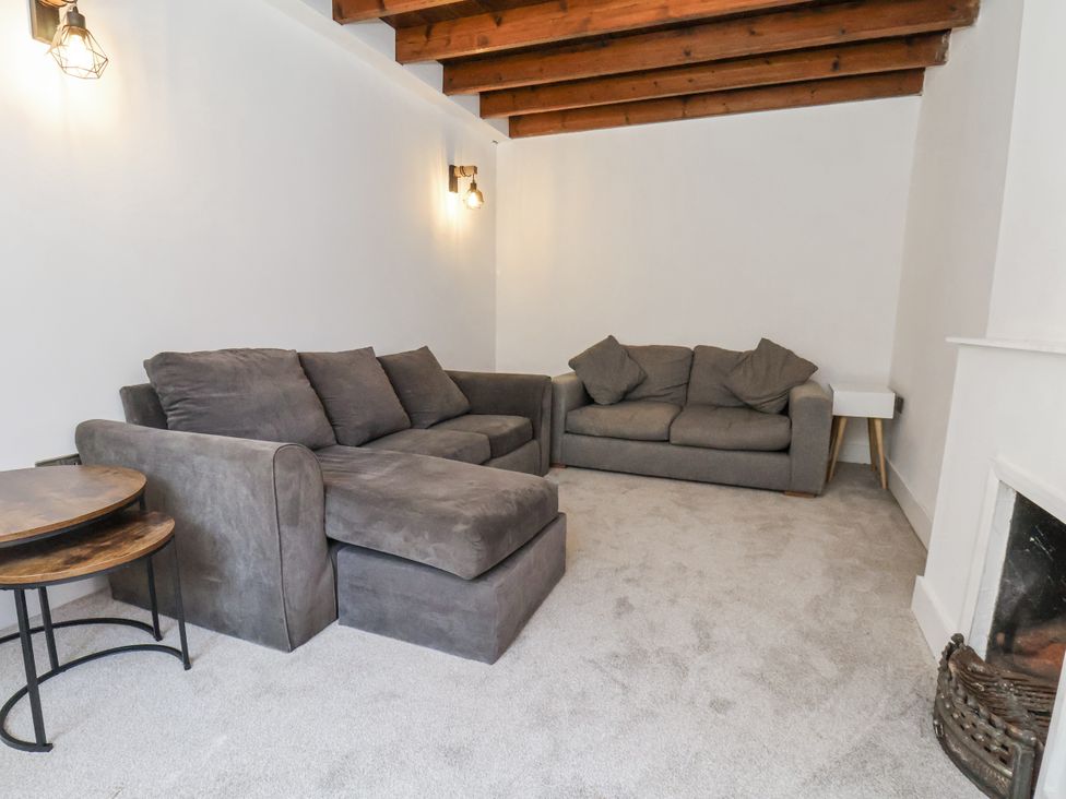 A living room with a sofa and armchair at Hemdin Cottage in Thornton Dale