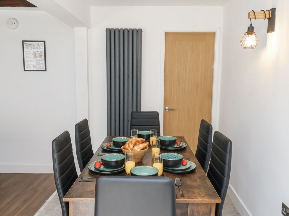 A dining room with a table set for breakfast at Hemdin Cottage in Thornton Dale