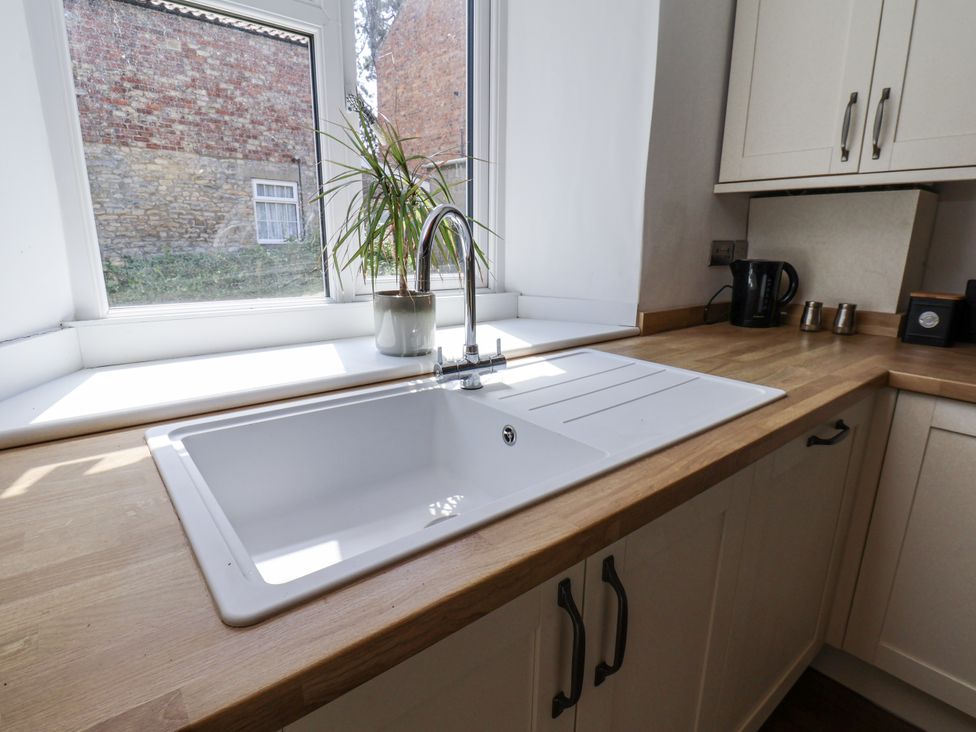 A kitchen with a sink and tap at Hemdin Cottage in Thornton Dale