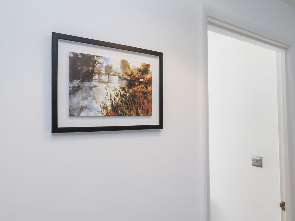 A painting on a wall next to a door at Hemdin Cottage in Thornton Dale