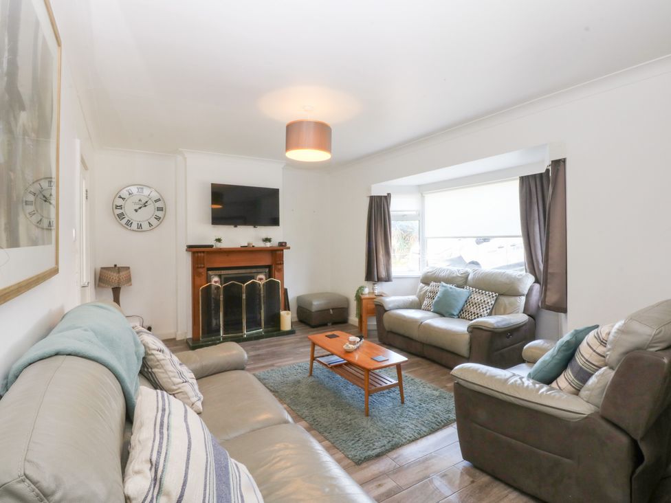 A living room with seating and a fireplace at Seabreeze in Llandudno