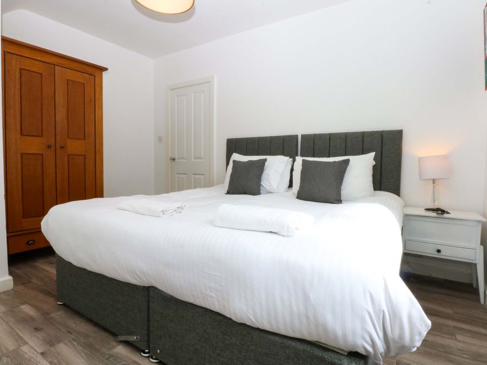 A bedroom with a double bed and wardrobe at Seabreeze in Llandudno