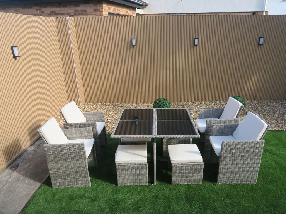 A seating area with a table and chairs at Seabreeze in Llandudno