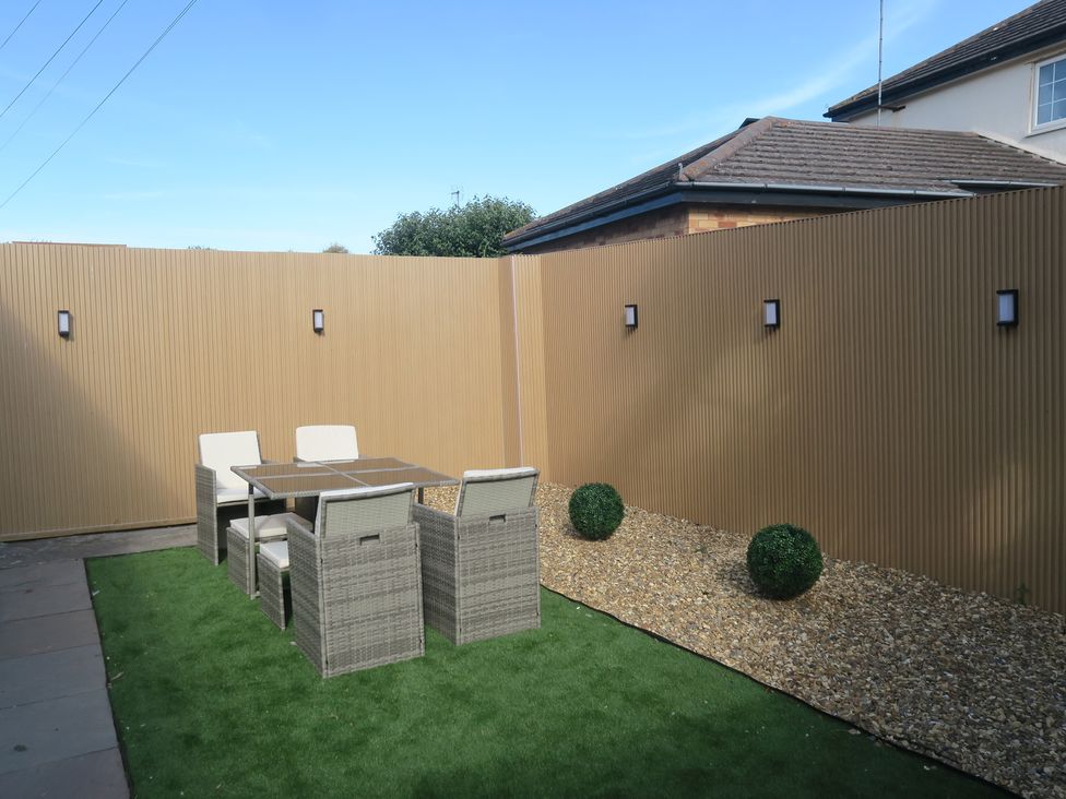 A garden with table and chairs at Seabreeze in Llandudno
