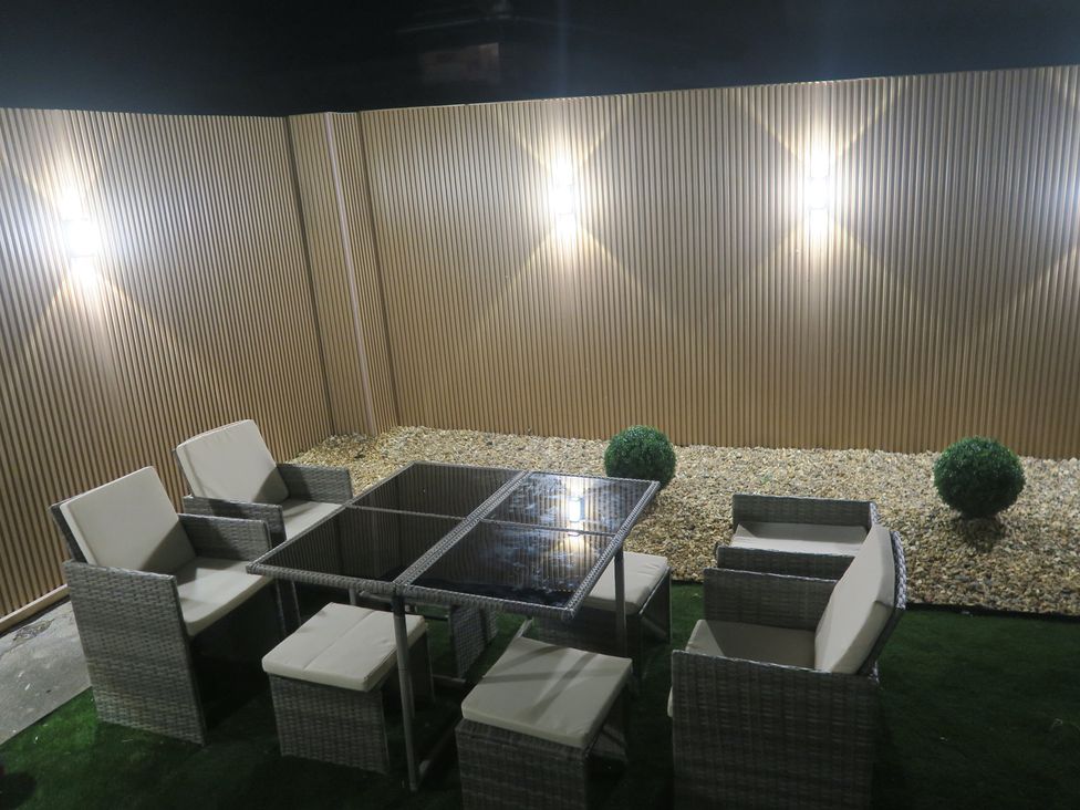 An outdoor seating area with a table and chairs at Seabreeze in Llandudno