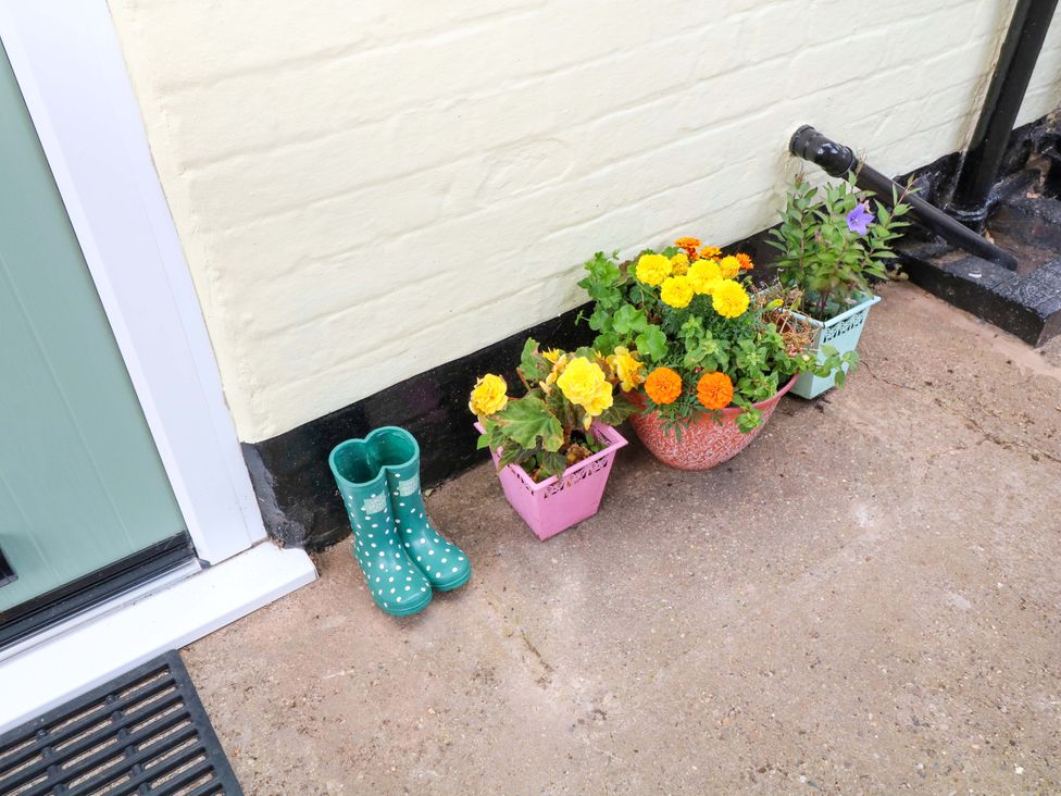 A pair of green boots and flower pots at 37 East Lane Mansfield