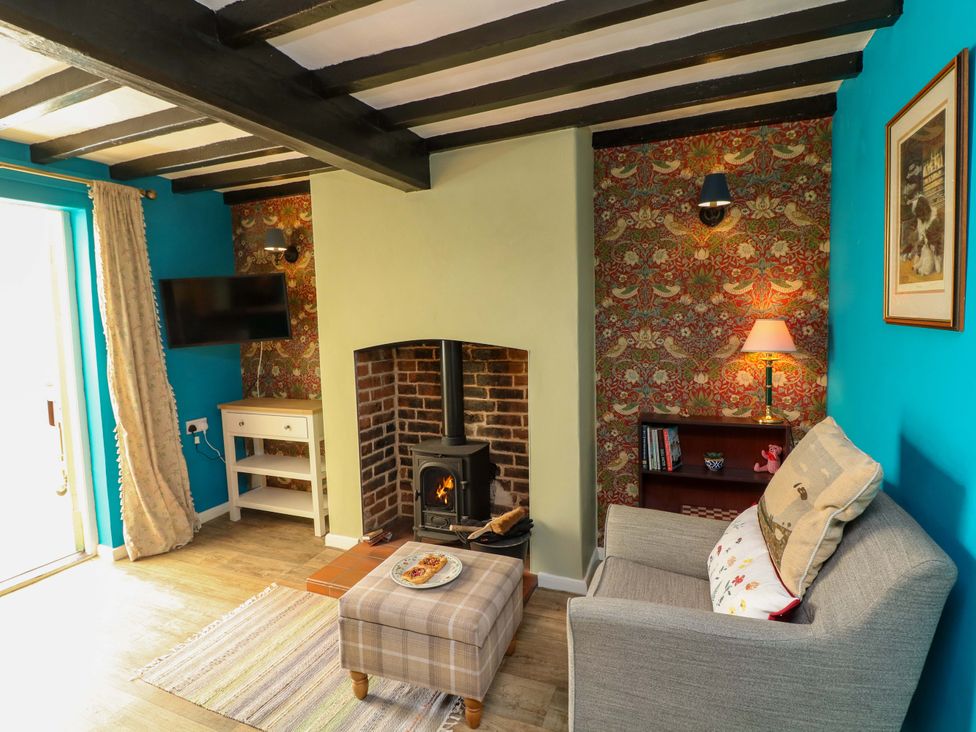 A living room with a fireplace and sofa at 37 East Lane in Mansfield