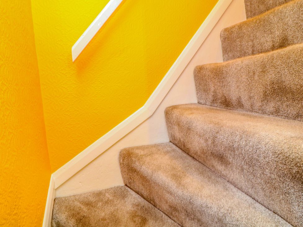Stairs with carpet and yellow wall at 37 East Lane Mansfield